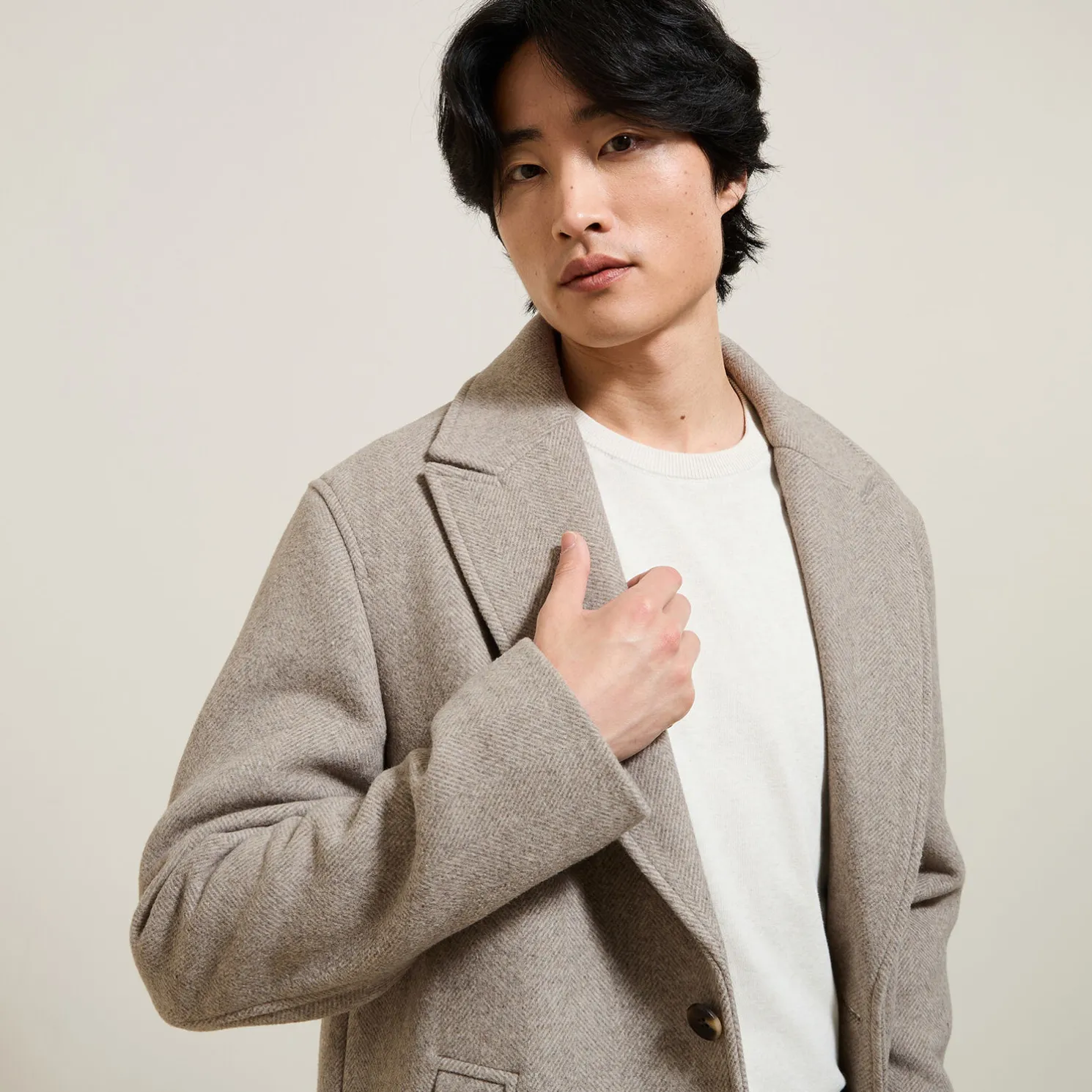 Lange mantel met visgraatmotief en reverskraag